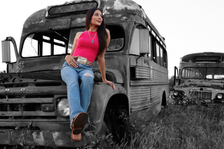 Cowgirl sitting on vintage bus